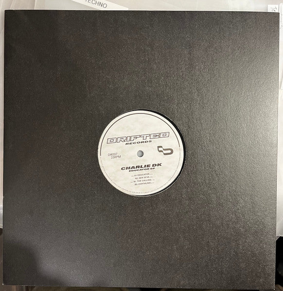 Image of Front Cover of 12" - /VG+ - CHARLIE DK, Educator EP (Drifted Records; DR007, UK 2026), , Drifted welcomes label founder Charlie DK to the imprint for DR007, with his debut Educator EP. Four club-focused tracks, shifting between high-pressure, peak time energy and stripped back, low-end weighted grooves. A release shaped over time, now ready for the dance floor. (Taken from Bandcamp). - 4126376E