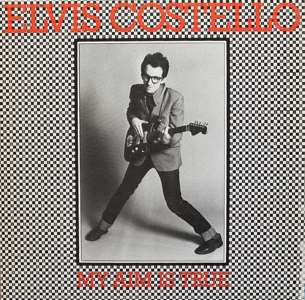 Image of Front Cover of LP - VG/G - ELVIS COSTELLO, My Aim Is True (Stiff Records; SEEZ 3, UK 1977, B&W Photo, Red Text, Purple Back), Light marks but lots of 'em. Black inner.,  - 4316179C