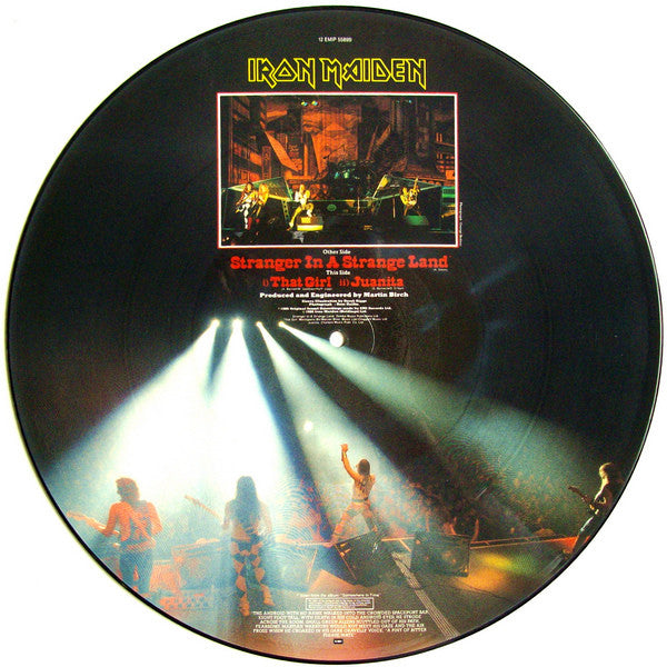 Image of Back Cover of 12" - /G+ - IRON MAIDEN, Stranger In A Strange Land (EMI; 12EMI5589, UK 1986, Picture Disc), Original plastic sleeve grubby and tatty.  Hairlines over record but picture intact. ,  - 2326337E