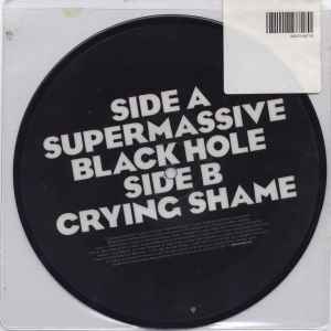 Image of Back Cover of 7" - VG/G+ - MUSE, Supermassive Black Hole (Warner Bros. Records; 5101-14871-7, UK 2006, Stickered Plastic Sleeve, Picture Disc), Vinyl has lots of light marks. Hype sticker opened & slightly torn.,  - 4216031C